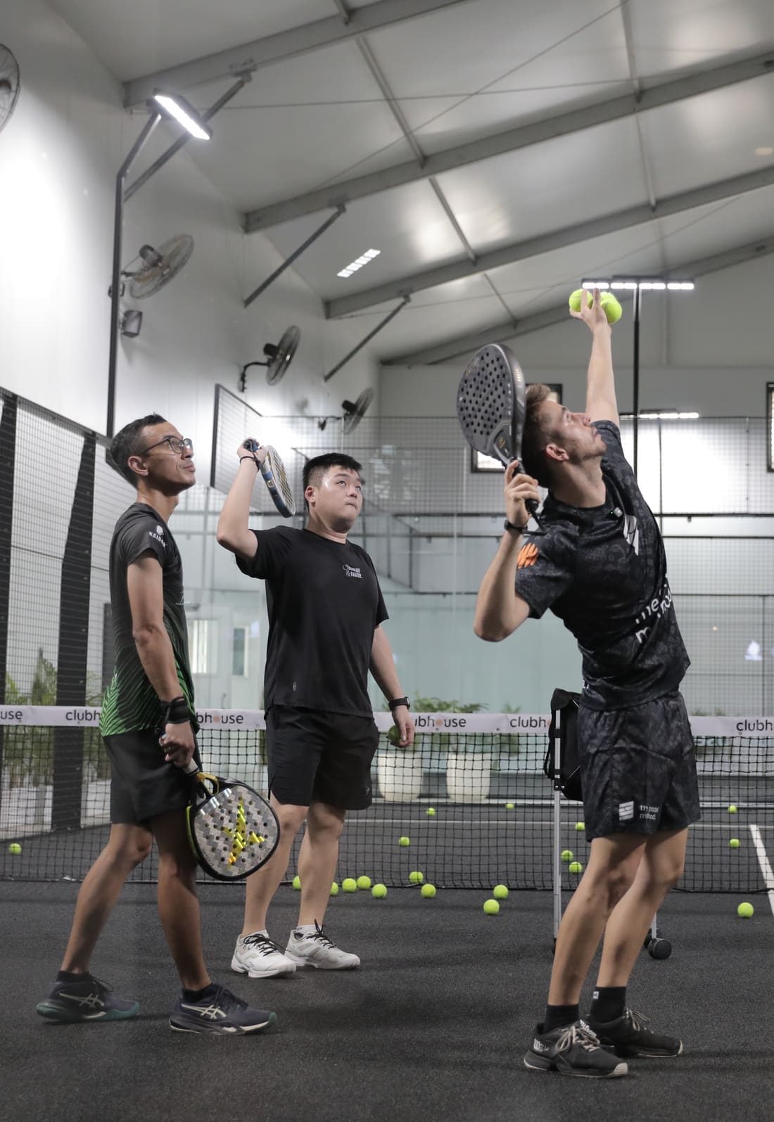 Three players on court during a session with their coach
